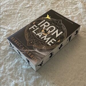 Iron Flame Paperback Book by Rebecca Yarros with dragon print edging